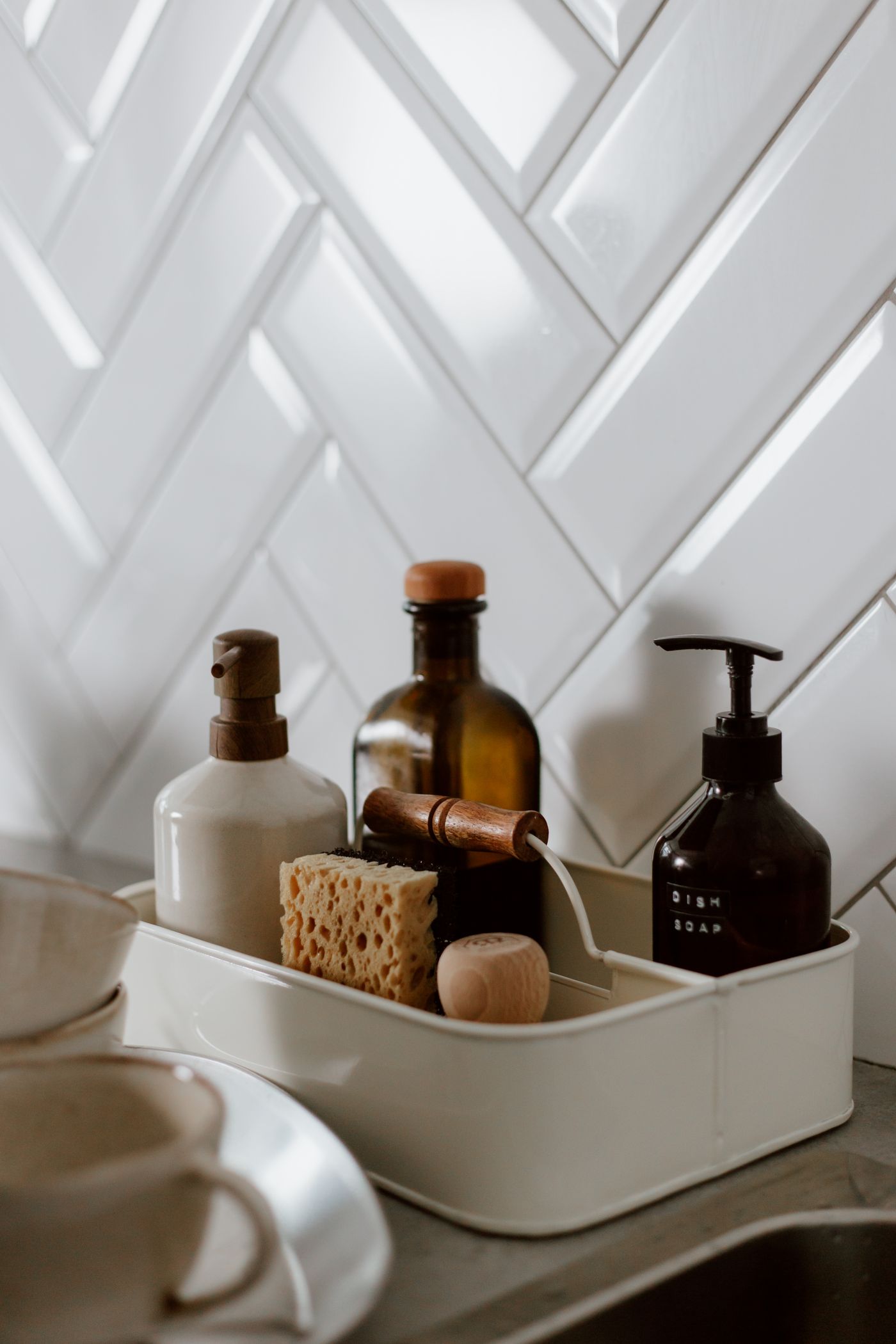 Cleaning products arranged beside a spotless kitchen sink